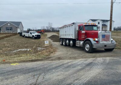 Dump truck unloading sand at a project site