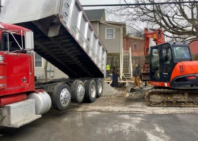 Dump truck unloading soil at excavation site