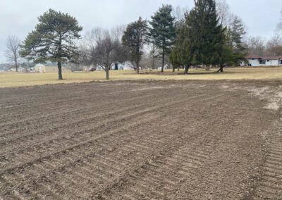 Grading machine smoothing soil surface