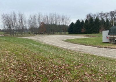Grading machine smoothing soil surface